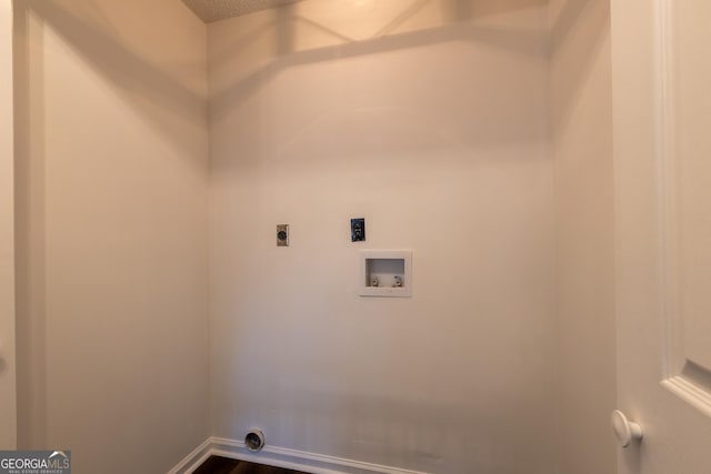 washroom with baseboards, washer hookup, dark wood-type flooring, and hookup for an electric dryer