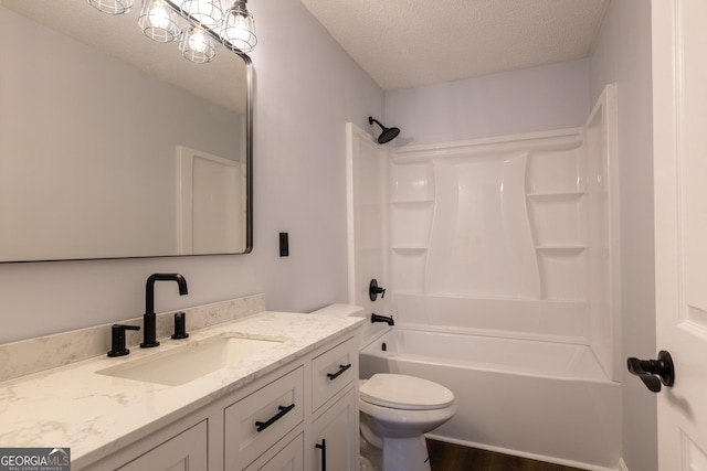 full bathroom featuring wood finished floors, a textured ceiling, vanity, shower / bath combination, and toilet
