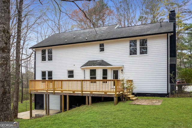 back of house with a patio, a lawn, a chimney, and a deck