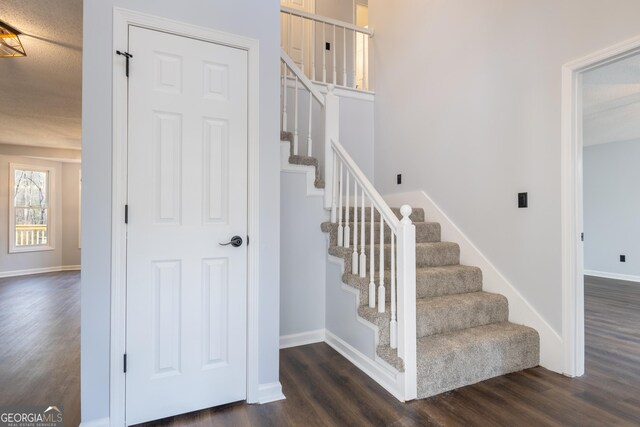 stairway with baseboards and wood finished floors