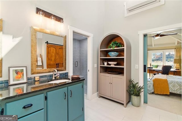 kitchen featuring a sink, blue cabinets, tasteful backsplash, and dark stone counters