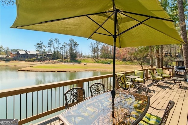 wooden deck featuring a water view, grilling area, and outdoor dining space