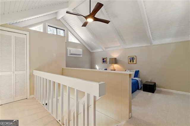 interior space with a closet, baseboards, ceiling fan, vaulted ceiling with beams, and carpet flooring