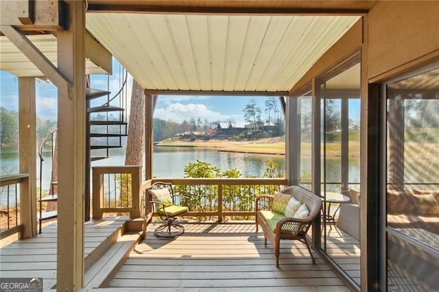 sunroom / solarium with a water view