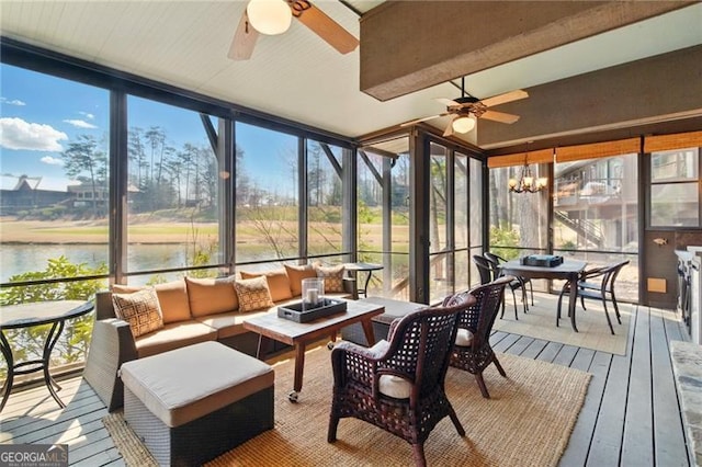 sunroom / solarium featuring outdoor lounge area, ceiling fan with notable chandelier, and a water view