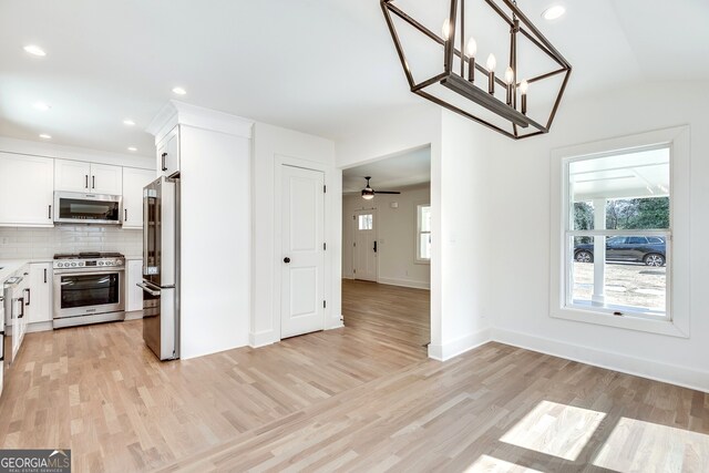 1861 Dyer Cir, Atlanta, GA 30341 - unfurnished dining area featuring lofted ceiling, light wood-style flooring, baseboards, recessed lighting, and a ceiling fan