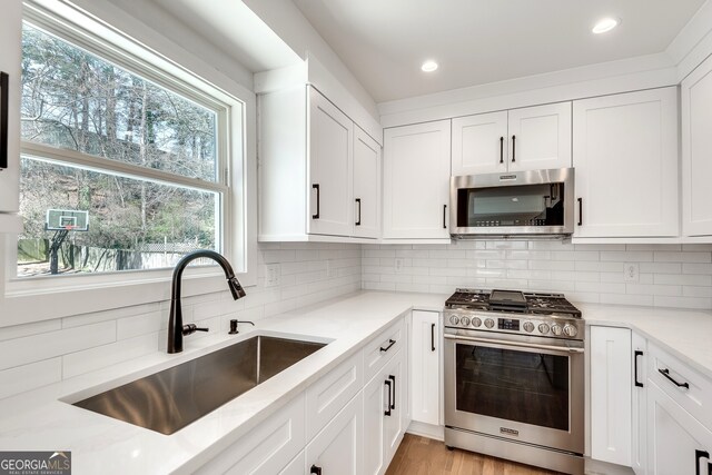 1861 Dyer Cir, Atlanta, GA 30341 - kitchen featuring white cabinets, appliances with stainless steel finishes, and a sink