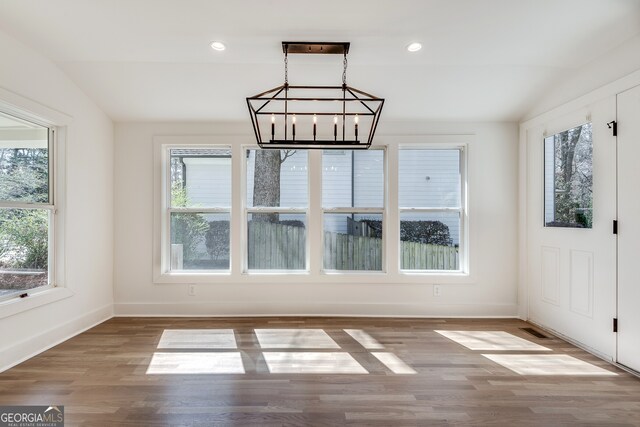 1861 Dyer Cir, Atlanta, GA 30341 - unfurnished dining area with an inviting chandelier, wood finished floors, lofted ceiling, and baseboards