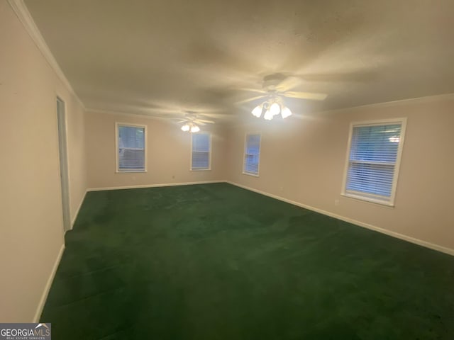 1311 Belmont Dr, Dublin, GA 31021 - spare room featuring a ceiling fan, ornamental molding, baseboards, and dark carpet