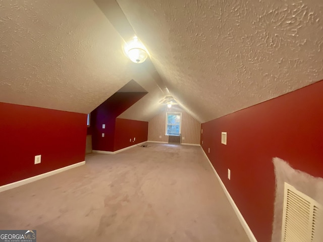 1311 Belmont Dr, Dublin, GA 31021 - bonus room with carpet, baseboards, vaulted ceiling, and a textured ceiling