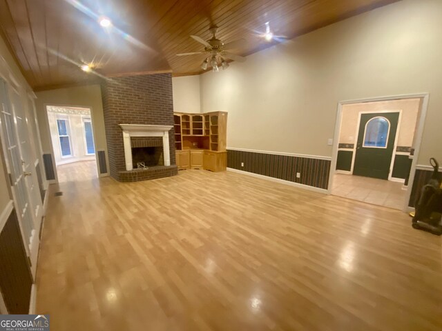 1311 Belmont Dr, Dublin, GA 31021 - unfurnished living room with ceiling fan, wood finished floors, wood ceiling, and a fireplace