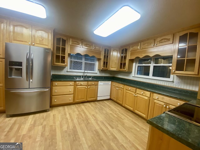 1311 Belmont Dr, Dublin, GA 31021 - kitchen with a sink, glass insert cabinets, light wood-type flooring, white dishwasher, and stainless steel refrigerator with ice dispenser