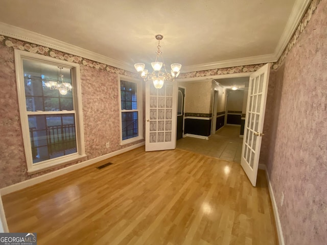1311 Belmont Dr, Dublin, GA 31021 - unfurnished dining area with visible vents, french doors, and a chandelier