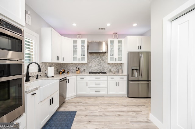 kitchen with light stone countertops, tasteful backsplash, appliances with stainless steel finishes, and visible vents