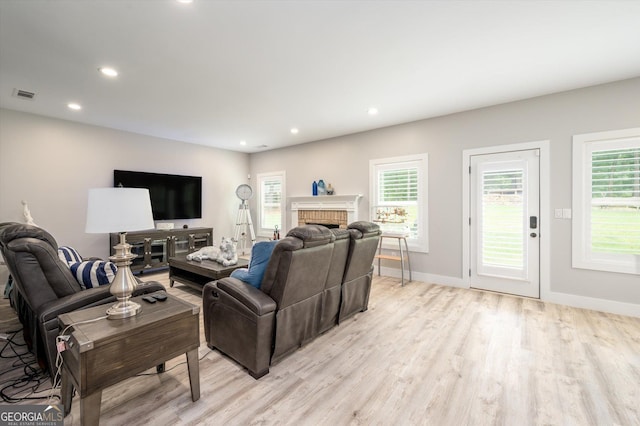 living room with recessed lighting, baseboards, light wood-style floors, and visible vents