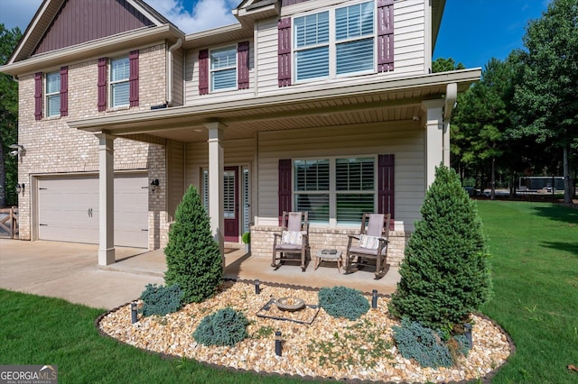 view of front facade featuring driveway, covered porch, an attached garage, and brick siding