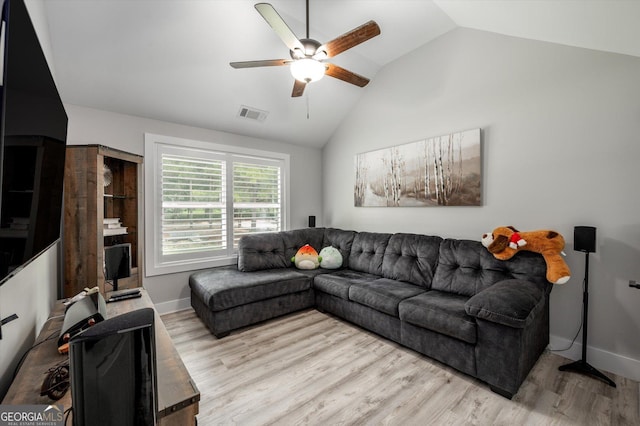 living area featuring vaulted ceiling, a ceiling fan, wood finished floors, baseboards, and visible vents