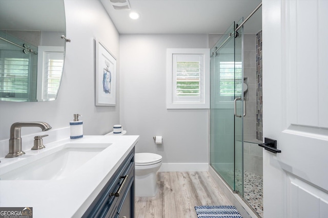 bathroom featuring visible vents, a stall shower, vanity, and wood finished floors