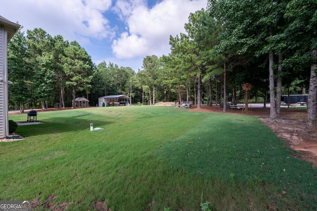 view of yard with a detached carport and a gazebo