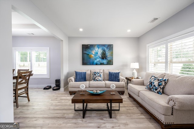 living area featuring recessed lighting, baseboards, visible vents, and light wood-type flooring