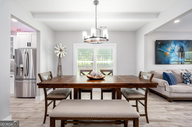 dining space featuring baseboards, beamed ceiling, light wood-type flooring, and a chandelier