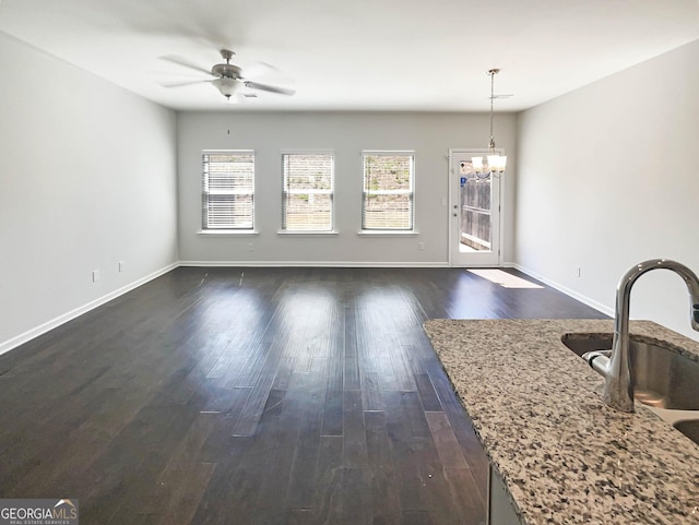 7109 Gladstone Cir, Lithonia, GA 30038 - unfurnished living room with a chandelier, a ceiling fan, and dark wood-style flooring