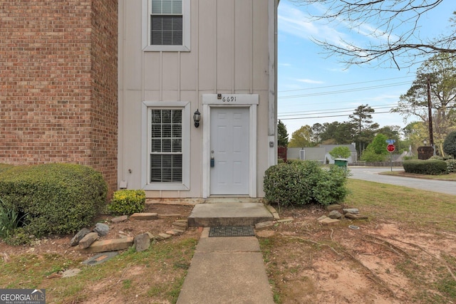 doorway to property with board and batten siding