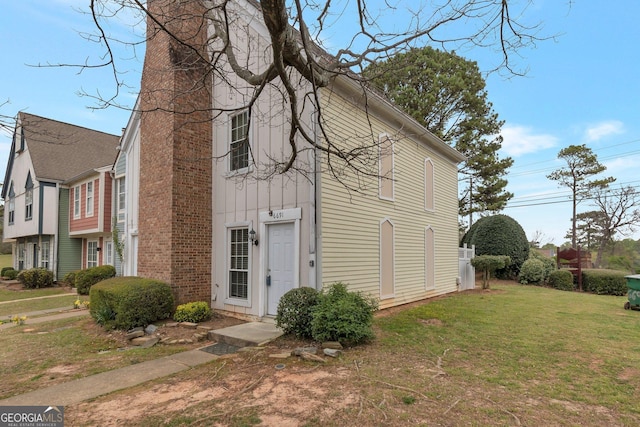 exterior space with a lawn and a chimney
