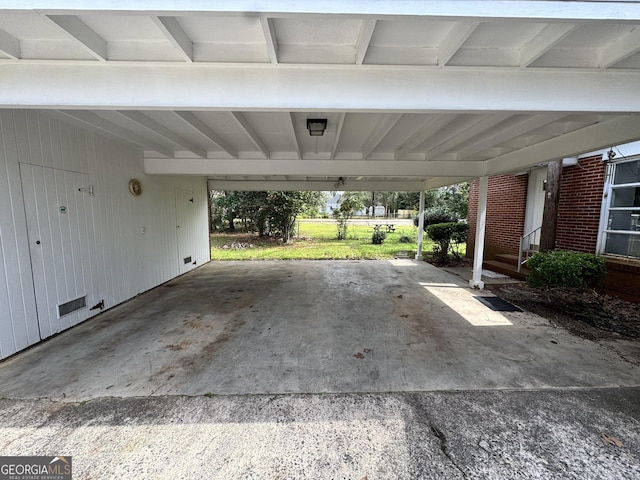 exterior space featuring an attached carport and concrete driveway