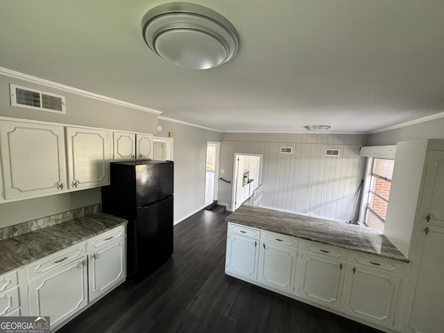 kitchen with white cabinetry, visible vents, ornamental molding, and freestanding refrigerator