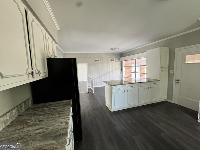 kitchen with dark wood-type flooring, white cabinetry, crown molding, and a peninsula