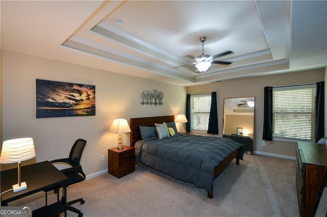 bedroom with baseboards, carpet, a tray ceiling, and ornamental molding