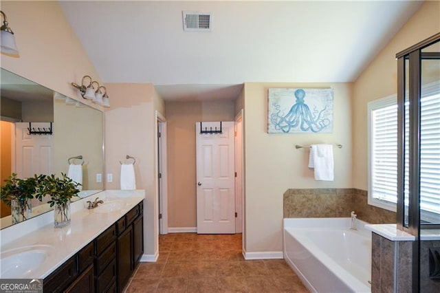 bathroom with a sink, visible vents, a bath, and baseboards