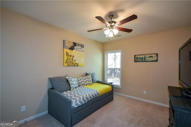 living area featuring light colored carpet, baseboards, a ceiling fan, and visible vents