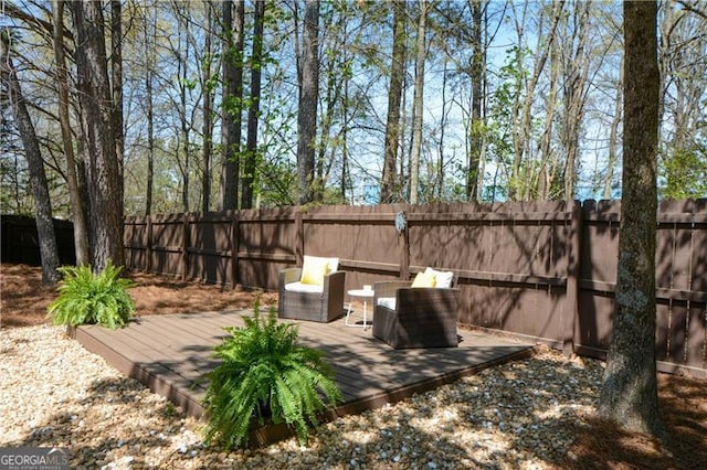 view of patio featuring a wooden deck and a fenced backyard