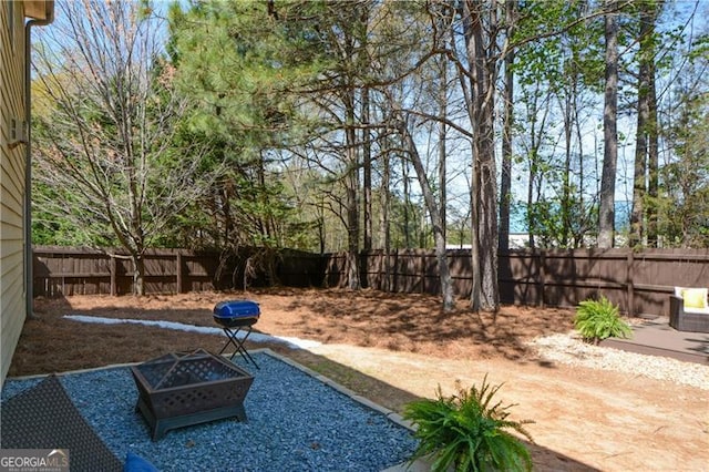 view of yard featuring an outdoor fire pit, a patio, and a fenced backyard