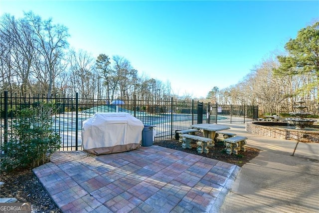 exterior space with a grill and fence