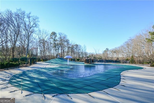 community pool featuring fence and a patio