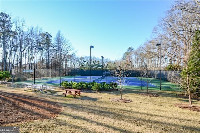 view of sport court featuring a yard and fence