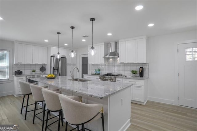 2041 Briarcliff Rd NE, Atlanta, GA 30329 - kitchen featuring wall chimney range hood, stainless steel fridge with ice dispenser, healthy amount of natural light, light wood-style floors, and recessed lighting