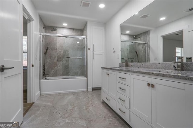 2041 Briarcliff Rd NE, Atlanta, GA 30329 - bathroom with double vanity, marble look tile flooring, bath / shower combo with glass door, and recessed lighting