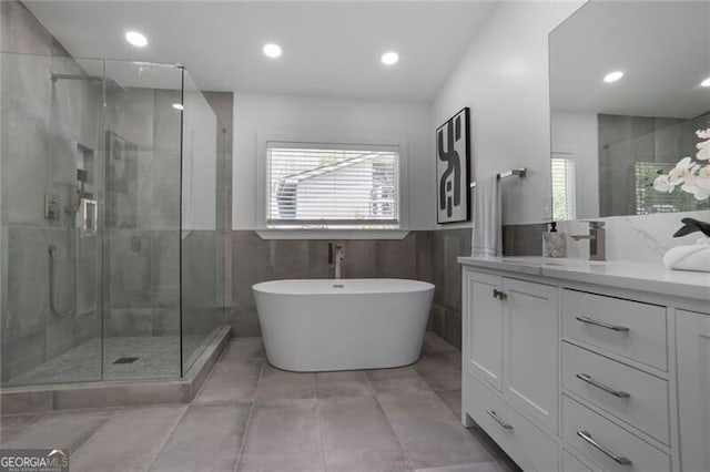 2041 Briarcliff Rd NE, Atlanta, GA 30329 - full bathroom featuring a shower stall, vanity, a freestanding bath, recessed lighting, and tile patterned floors