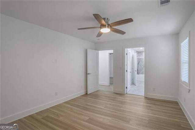 2041 Briarcliff Rd NE, Atlanta, GA 30329 - unfurnished bedroom featuring light wood-style floors, multiple windows, ensuite bath, and ceiling fan