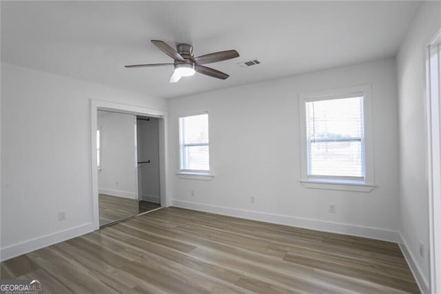 2041 Briarcliff Rd NE, Atlanta, GA 30329 - unfurnished bedroom featuring wood finished floors, a closet, and ceiling fan