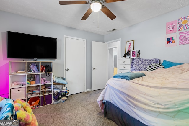 bedroom with a ceiling fan, visible vents, and carpet floors