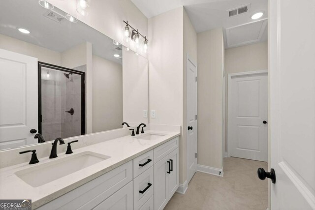 full bathroom with a stall shower, double vanity, visible vents, and a sink