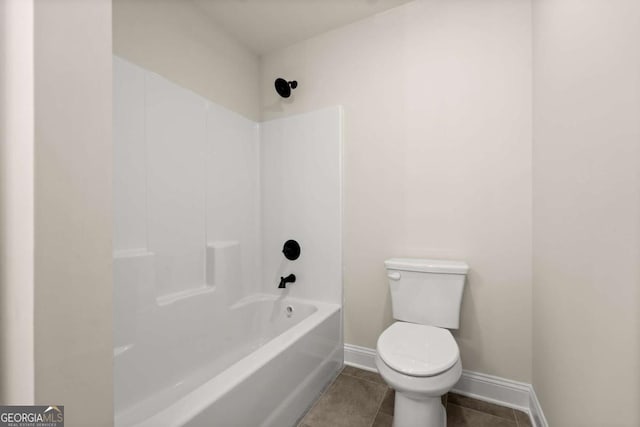 full bathroom with baseboards, toilet, tile patterned flooring, and shower / bathtub combination