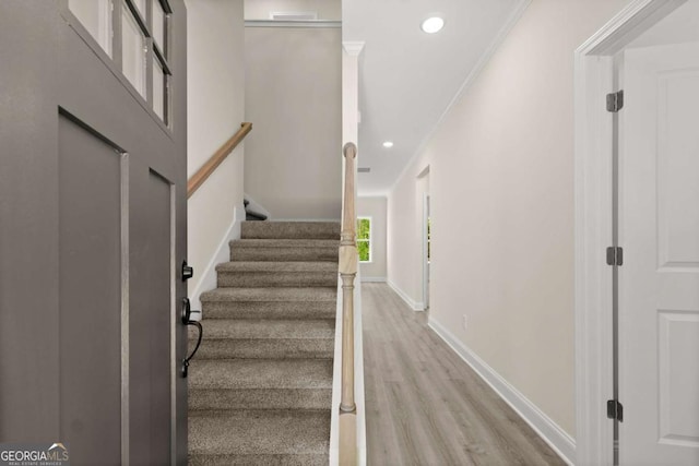 staircase with baseboards, recessed lighting, wood finished floors, and ornamental molding