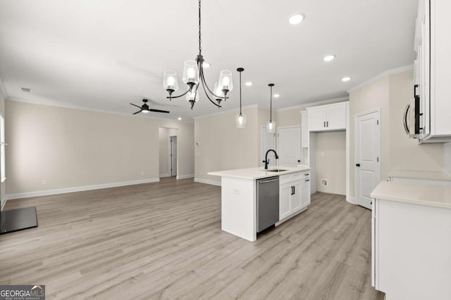 kitchen with stainless steel appliances, white cabinetry, a sink, ceiling fan with notable chandelier, and open floor plan
