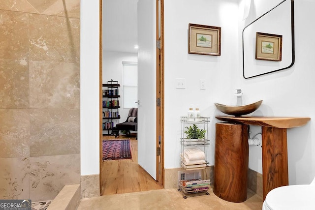 bathroom featuring toilet and wood finished floors
